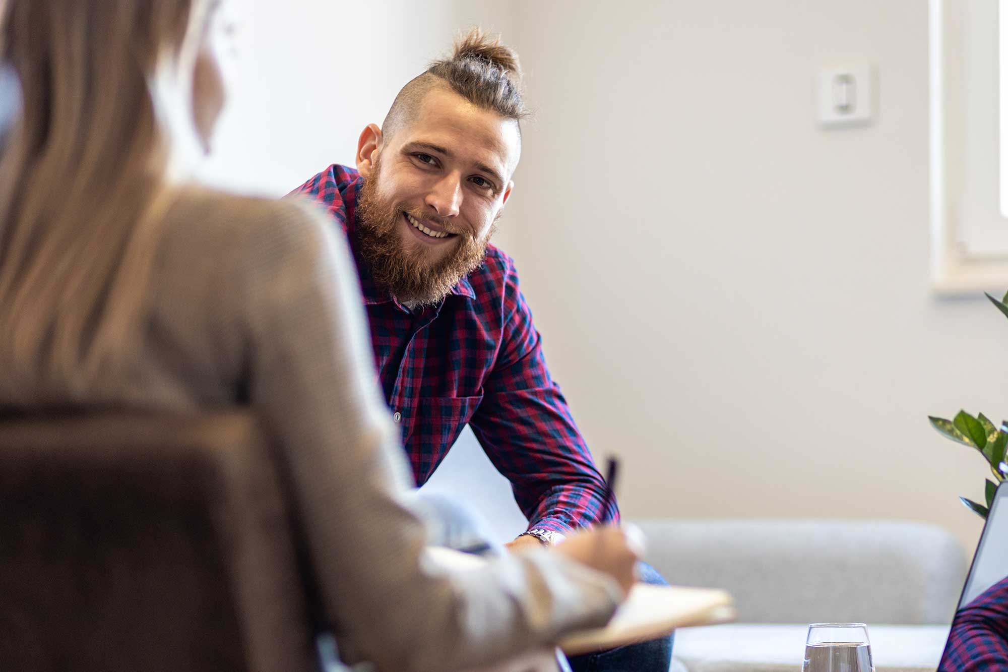 Smiling adult talking with a psychologist