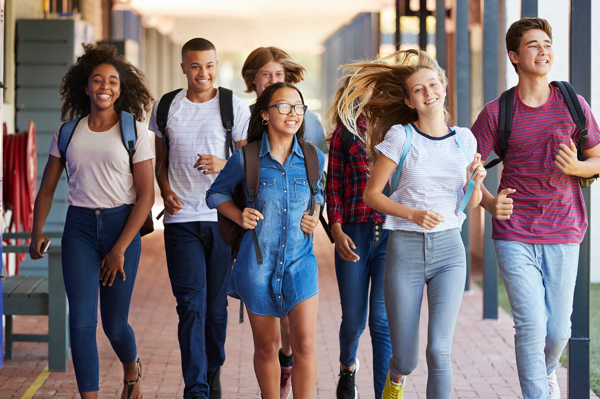 Group of teenagers walking down a hallway