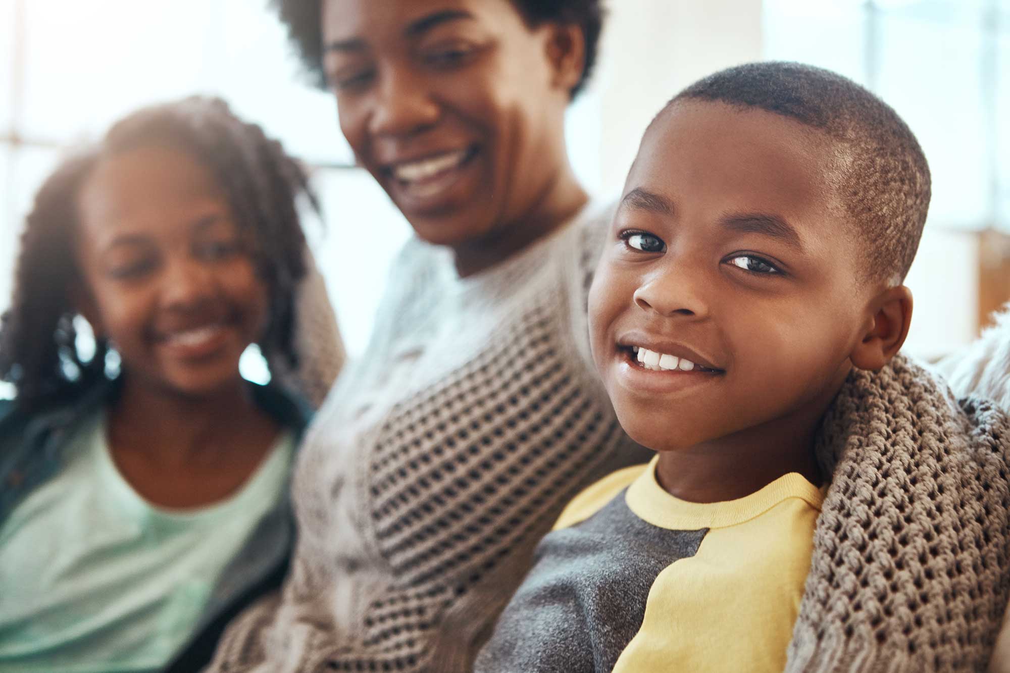 Smiling family sitting together.