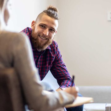 Smiling adult talking with a psychologist