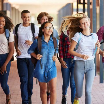 Group of teenagers walking down a hallway