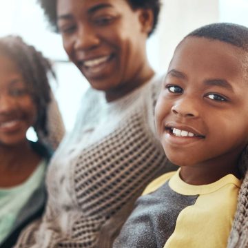 Smiling family sitting together.