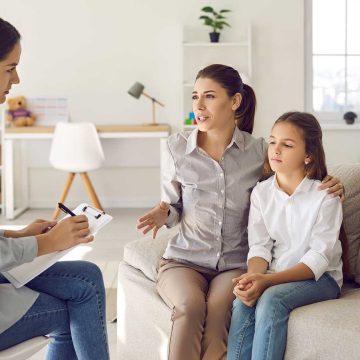 A parent and child talking with a psychologist
